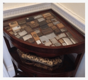 A Desk With Stamp Boxes On Show Under The Glass Top - Desk #1336610