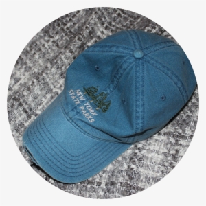 A Faded Dark Blue Jean Baseball Cap Sits On A Grey - Baseball Cap #2935318