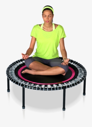 A Woman Sits Meditating Cross Legged On A Bellicon® - Trampolin Bellicon #9716470